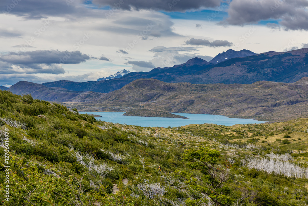 Naklejka premium Torres del Paine national park mountain landscape in Patagonia, Chile. Los Cuernos and Torres del Paine peak granite towering summits on a nasty and sunny day above the blue water lake in the Andes