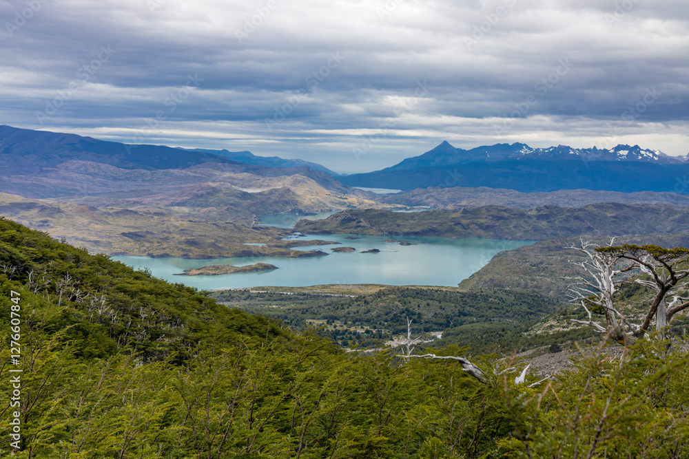 Torres del Paine national park mountain landscape in Patagonia, Chile. Los Cuernos and Torres del Paine peak granite towering summits on a nasty and sunny day above the blue water lake in the Andes Torres del Paine national park mountain landscape in Patagonia, Chile. Los Cuernos and Torres del Paine peak granite towering summits on a nasty and sunny day above the blue water lake in the Andes