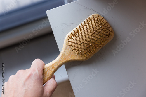 Wooden hairbrush with loose hair