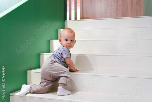 A toddler climbing the stairs in a playroom