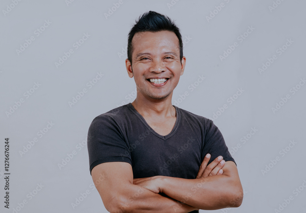 Cheerful asian man smiling happy to camera, posing crossing hands and standing on white background. Studio shot of happy self-confident and positive emotions. Cheerful asian man smiling happy to camera, posing crossing hands and standing on white background. Studio shot of happy self-confident and positive emotions.