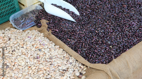 buckets of dried beans of various varieties for sale by weight at the produce market photo