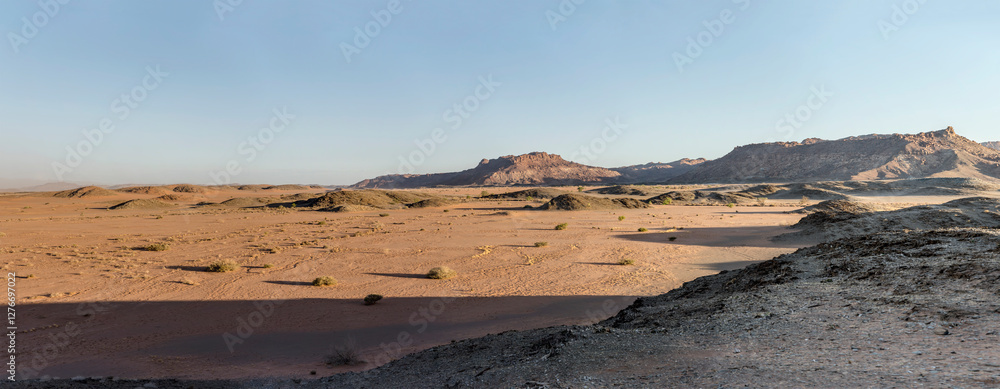 sandy desert and rocky hills from above, near Twyfelfontein, Namibia