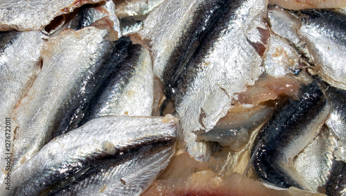 Lightly salted sprat fillet.Baltic sprat with spicy salt.Sprat is a fish of the herring family. photo