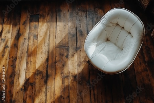 Modern White Chair on Wooden Floor Illuminated by Sunlight in a Spacious Room
