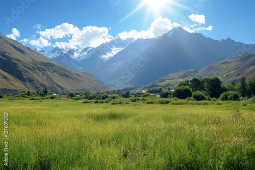 Obraz na płótnie A breathtaking mountain landscape arises majestically under the bright, golden sun, surrounded by lush, vibrant greenery, with a charming village nestled in the serene valley below w salonie