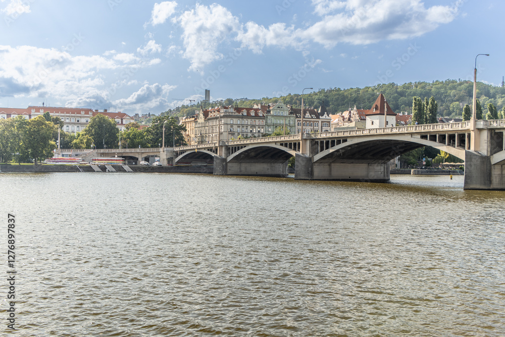 Naklejka premium View of Lesser Town and Petrin hill over the Vltava river near the Jiraskuv bridge in Prague.
