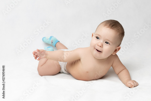 A happy baby reaches out to his parents