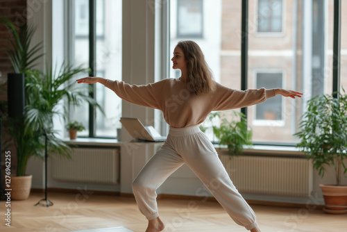 Woman practicing yoga in a sunlit room surrounded by indoor plants