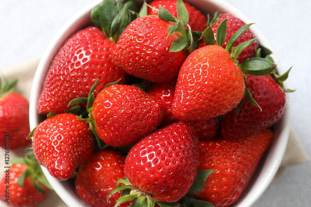 Delicious fresh red strawberries in a bowl on a wooden background Delicious fresh red strawberries in a bowl on a wooden background