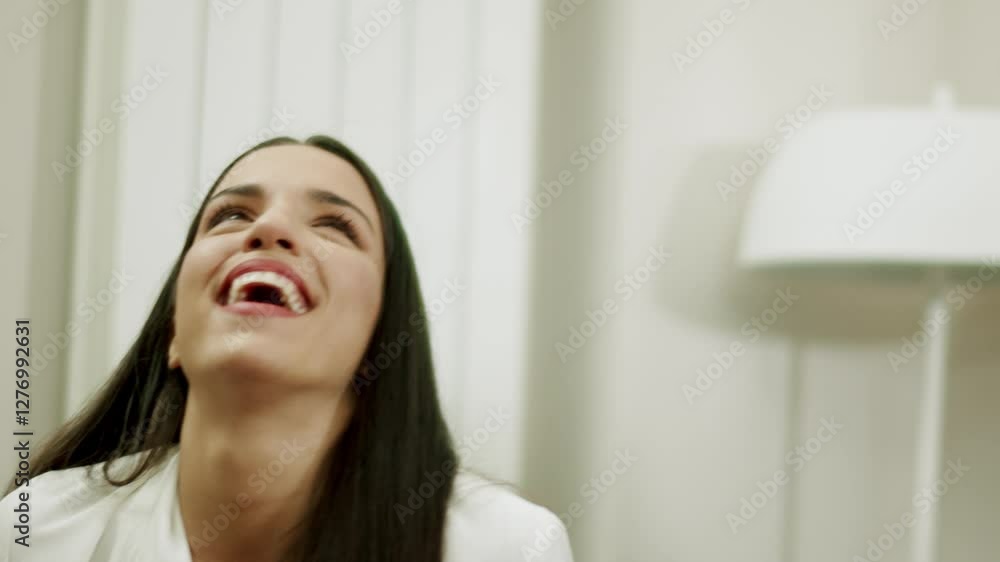 Group of young people laughing in living room. Slow motion Group of young people laughing in living room. Slow motion