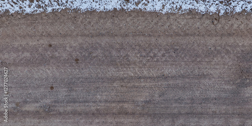 view from above on texture of dry road with tractor tire tracks in countryside.