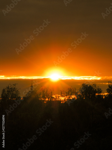 silhouette of a dome and trees against a beautiful sunset sky