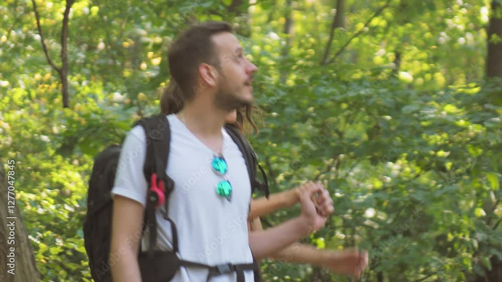Happy couple enjoying a nature hike, holding hands and smiling in a sunlit forest, showcasing a shared love for outdoor activities. Happy couple enjoying a nature hike, holding hands and smiling in a sunlit forest, showcasing a shared love for outdoor activities.