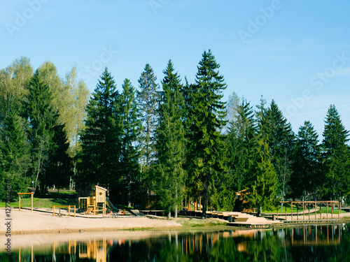 modern wooden playground on the lake shore