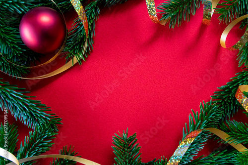 Winter red background with decor and branch of Christmas tree. photo