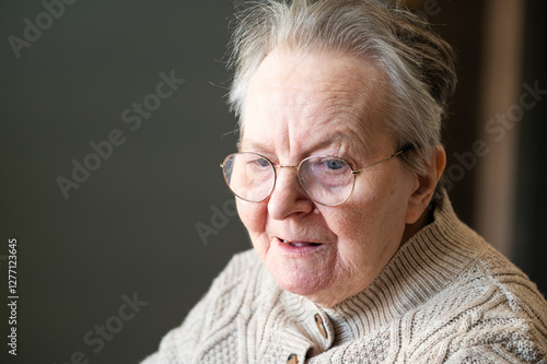 Expressive portrait of an 86 yo grandmother sitting in a wheelchair home in Tienen, Flemish Brabant, Belgium photo