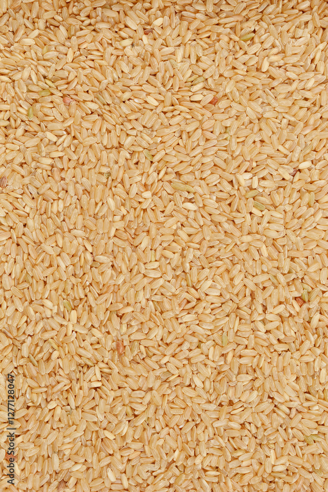 A close-up, overhead shot of a pile of brown rice grains showcases their natural texture and earthy color, emphasizing their wholesomeness and dietary value A close-up, overhead shot of a pile of brown rice grains showcases their natural texture and earthy color, emphasizing their wholesomeness and dietary value