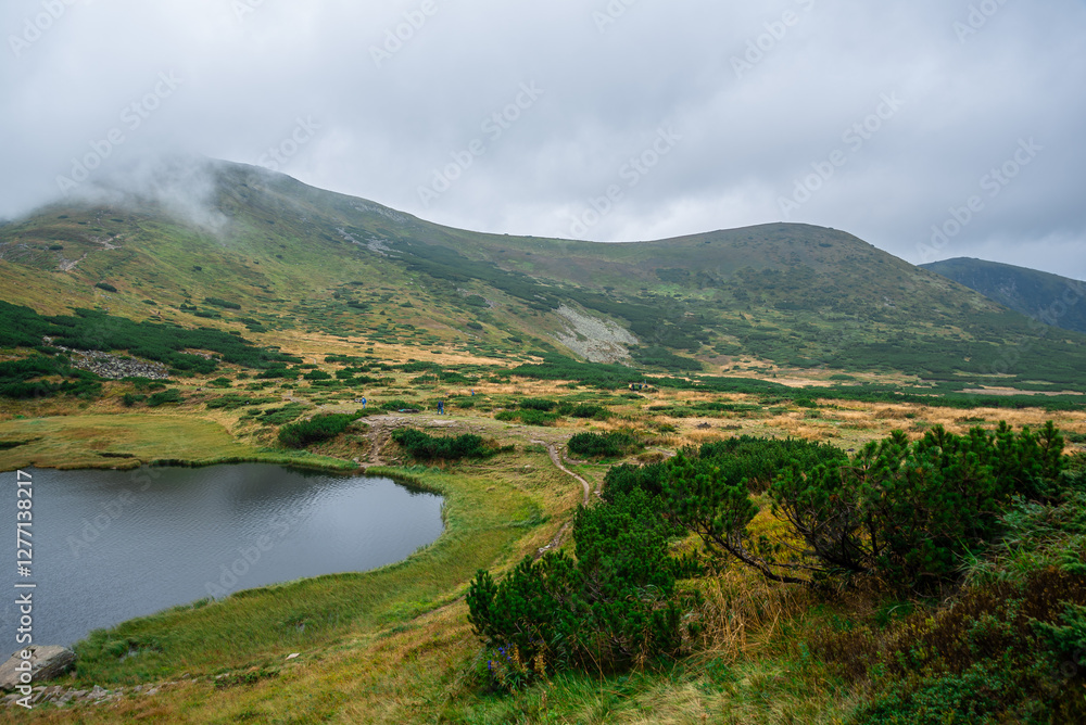 Obraz premium Beautiful clouds on the mountains , landscape photo on mountains , stones on the ground, fog . Summer landscape 