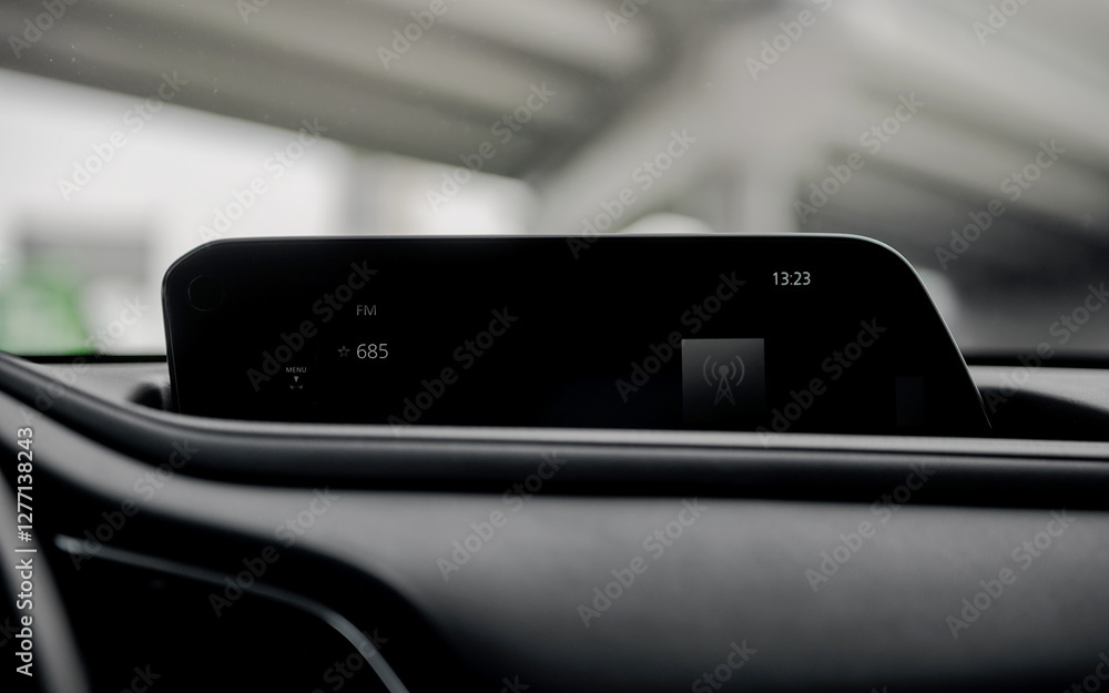 Close up shot of infotainment system in the car. Listening to radio while driving under a bridge on a sunny day.
Close up shot of infotainment system in the car. Listening to radio while driving under a bridge on a sunny day.