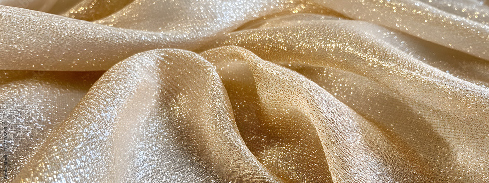 A shiny, shimmering golden satin fabric with subtle glitter accents.
A shiny, shimmering golden satin fabric with subtle glitter accents.