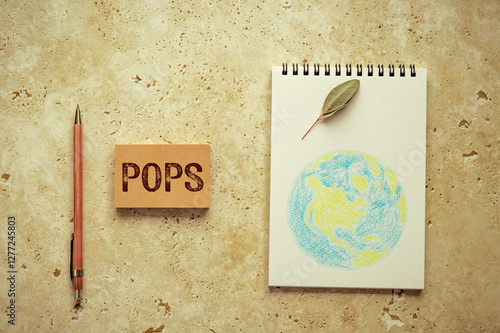 There is sticky note with the word POPS. It is an abbreviation for Persistent Organic Pollutants as eye-catching image. photo