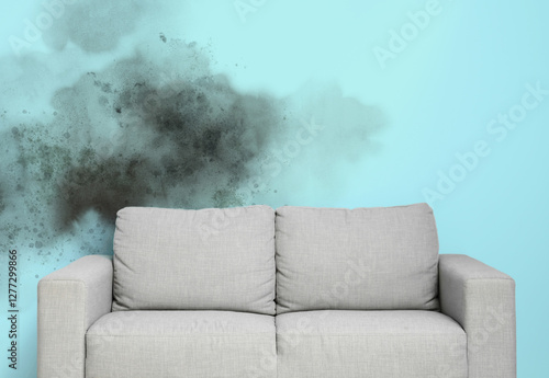 Cozy grey sofa near blue wall