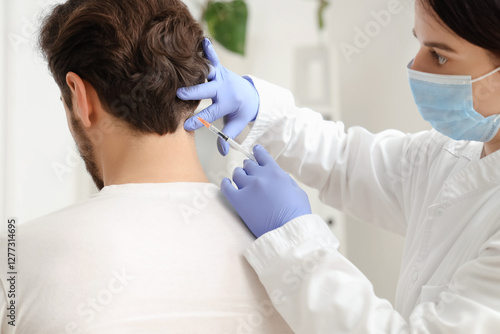 Young man receiving injecti...