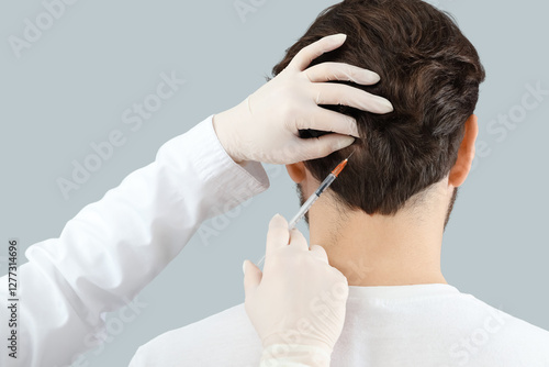 Young man receiving injecti...