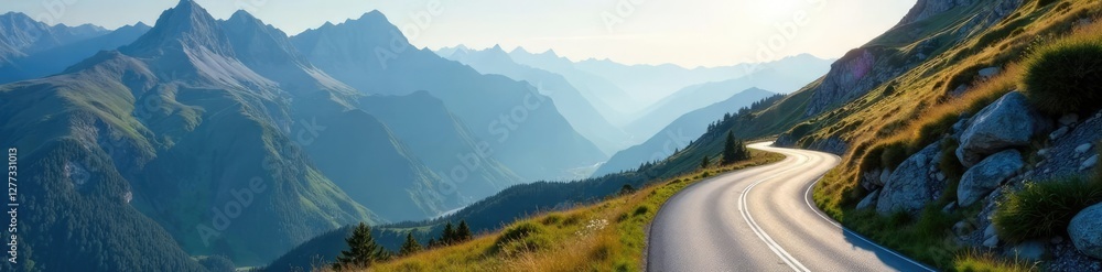 Fototapeta premium A winding road disappears into the distance up the side of a mountain, alpine environment, landscape, winding road