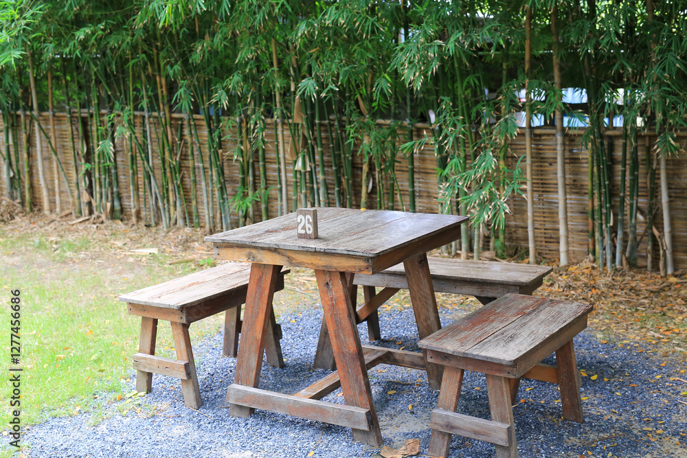 Wooden table and benches in the garden. Garden furniture for outdoor recreation. Wooden table and benches in the garden. Garden furniture for outdoor recreation.