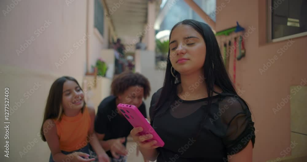 Teenager showing regret and frustration over social media post while friends laugh and point in suburban alleyway, expressive moment showcasing digital culture dynamics