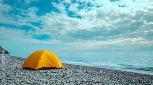 Serene Beach Camping, A Yellow Tent Under a Cloudy Sky with a Calm Ocean View photo