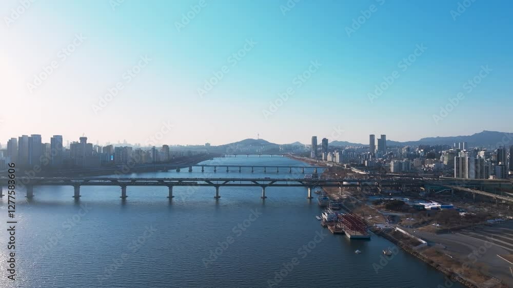 Aerial view of Seoul, South Korea, with the Hangang River winding through the city, video by towering skyscrapers and historical landmarks Aerial view of Seoul, South Korea, with the Hangang River winding through the city, video by towering skyscrapers and historical landmarks