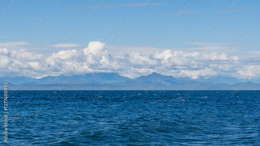 panorama view from the shore of Malcolm Island beautiful water of the ocean with clouds on blue sky panorama view from the shore of Malcolm Island beautiful water of the ocean with clouds on blue sky