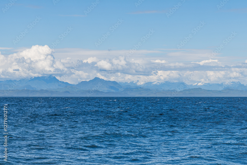 panorama view from the shore of Malcolm Island beautiful water of the ocean with clouds on blue sky panorama view from the shore of Malcolm Island beautiful water of the ocean with clouds on blue sky