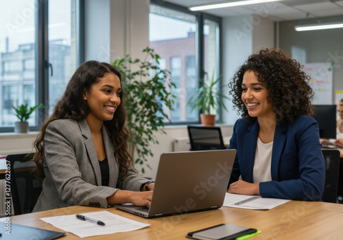 Photo of a pair of employees working together on office work