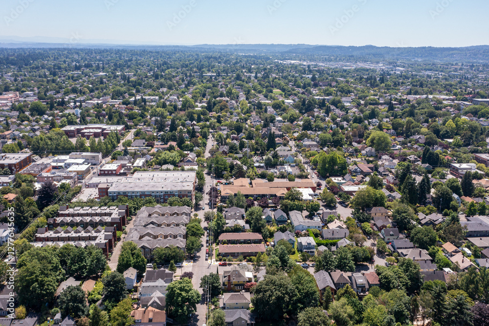 Aerial drone view of Northeast Portland, Oregon, showcasing residential homes, tree-lined streets, urban landscape, and cityscape with Mount Hood and Mount St. Helens visible in the background Aerial drone view of Northeast Portland, Oregon, showcasing residential homes, tree-lined streets, urban landscape, and cityscape with Mount Hood and Mount St. Helens visible in the background