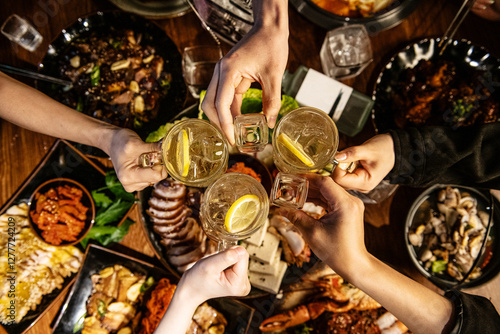 Group of friends with drinks on the table in a restaurant. Top view