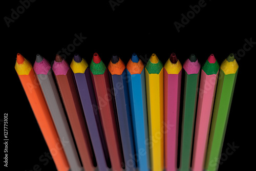 colored pencils on black background
