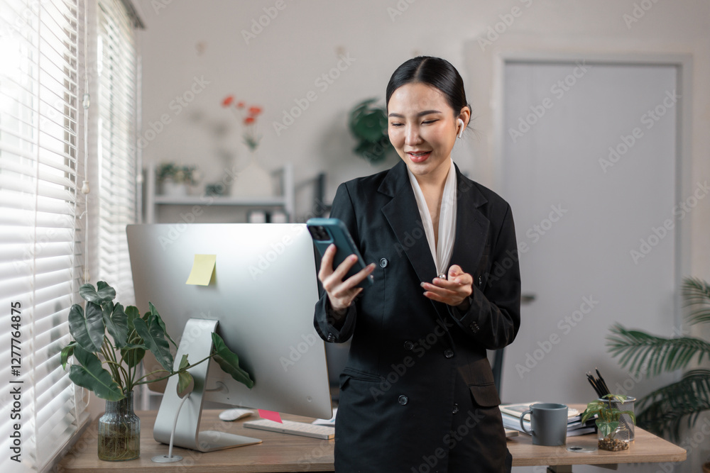 Happy asian woman using mobile phone sitting in workplace. lady holding smartphone talk about business analytics, Copy space.
Happy asian woman using mobile phone sitting in workplace. lady holding smartphone talk about business analytics, Copy space.