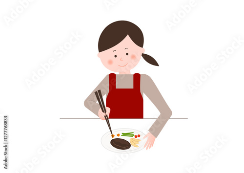 料理の盛り付けをする女性