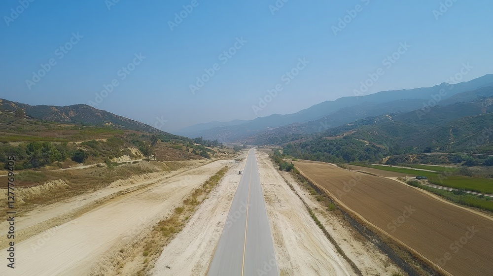 Aerial View of a Highway Cutting Through a Mountainous Landscape Aerial View of a Highway Cutting Through a Mountainous Landscape