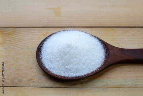 Monosodium glutamate in bowl on wooden background. photo