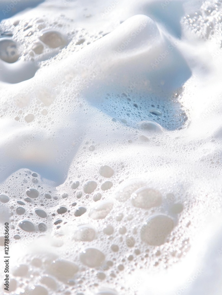 Close-up of foamy ocean waves with bubbles under sunlight
