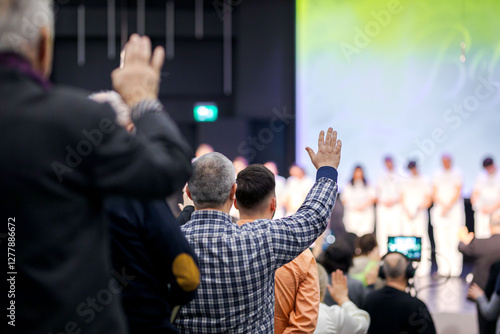 People who raise their hand in worship in a church