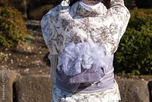 Young girl wearing Japanese kimono standing in front of Sensoji Temple in Tokyo, Japan. Kimono is a Japanese traditional garment. The word 