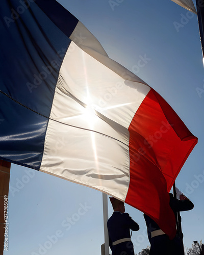 French flag waving in the wind with sunlight