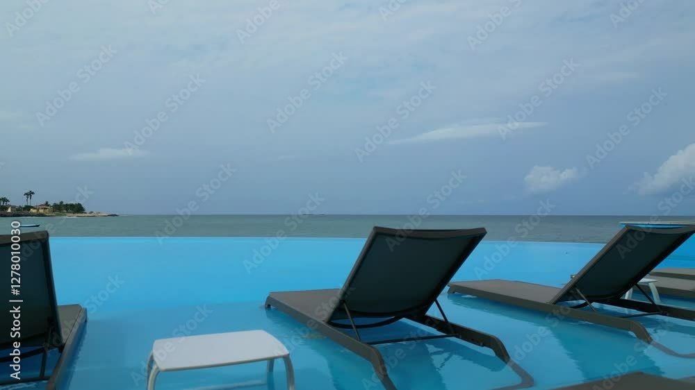 View of chairs and a table in an infinity pool, São Tomé,Africa View of chairs and a table in an infinity pool, São Tomé,Africa