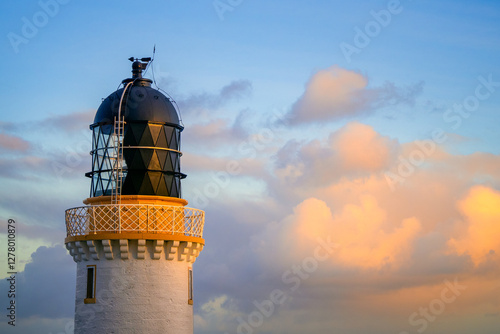 Dunnet Head Lighthouse under a clouded sunrise sky in Scotland, Europe photo